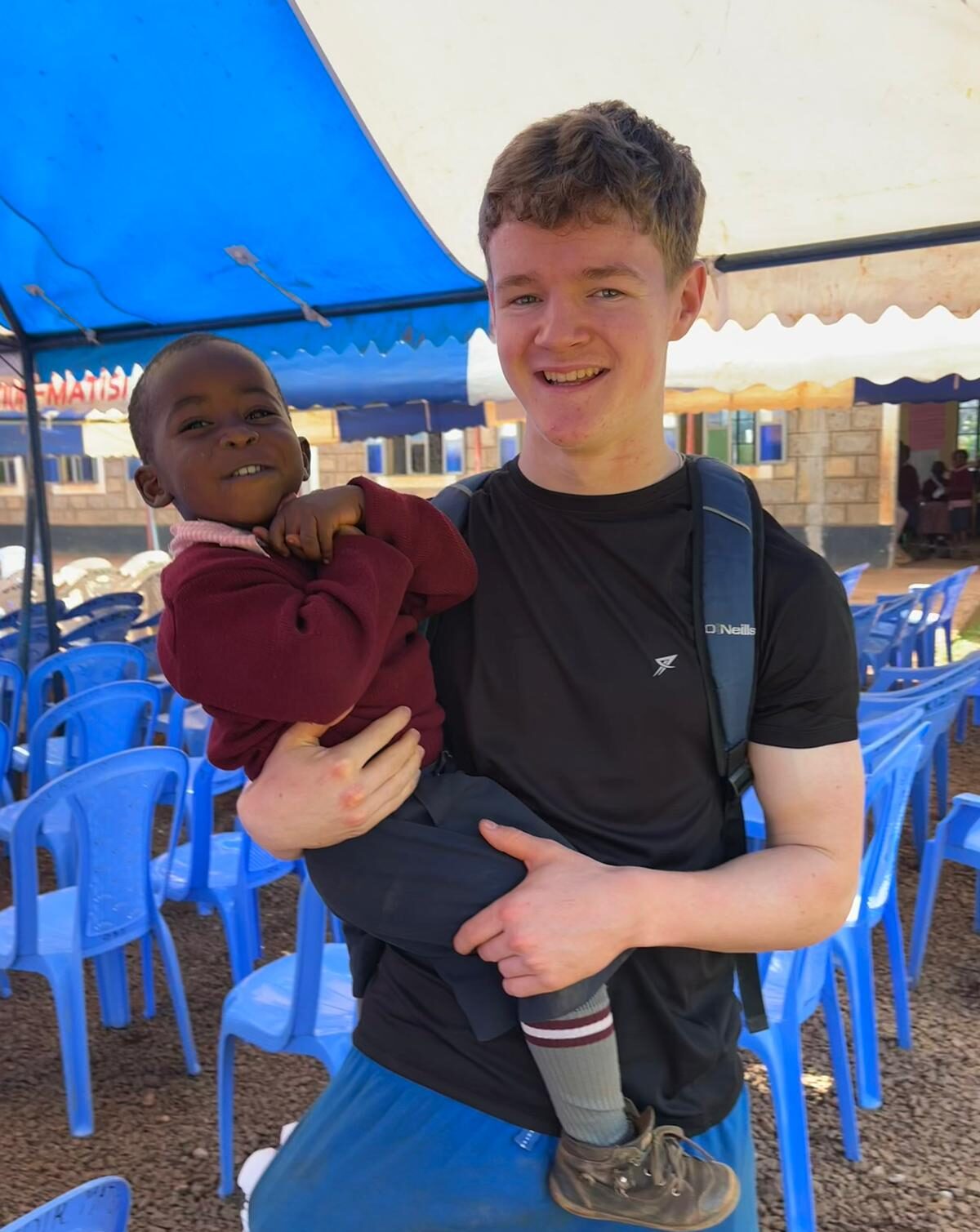 Luke carrying one of the children.