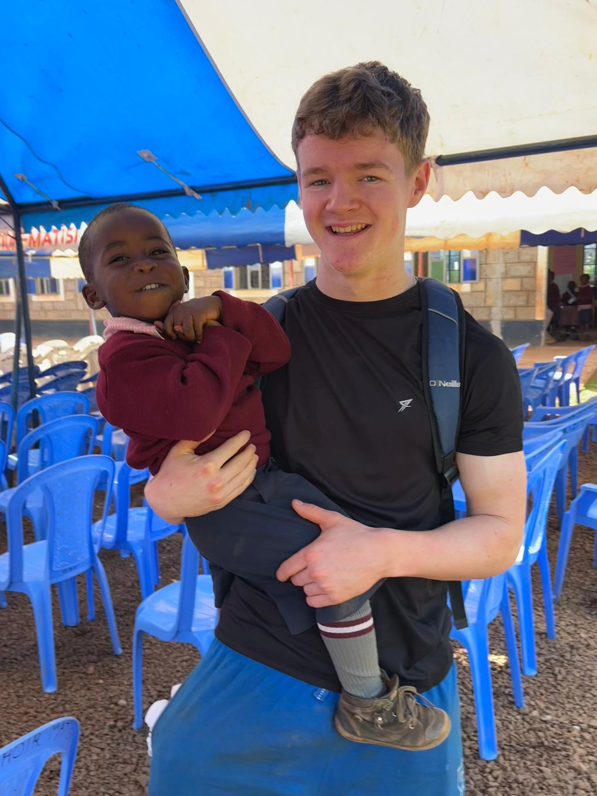 Luke carrying one of the children.